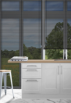 Soft Black - A classic soft tone black venetian blind that works perfectly in a kitchen or bathroom. The blind is custom made from aluminium and available in a 25mm slat size.
