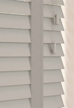 Marlin 50mm Basswood & Solis Tape - This bespoke basswood blind, featuring a sleek 50mm slat width and coordinating decorative tape, effortlessly brings elegance to any space. Crafted from sustainable wood to offer optimal light regulation and privacy, it seamlessly elevates your home's atmosphere. Moreover, its versatile grey tone blends well with any interior design.
